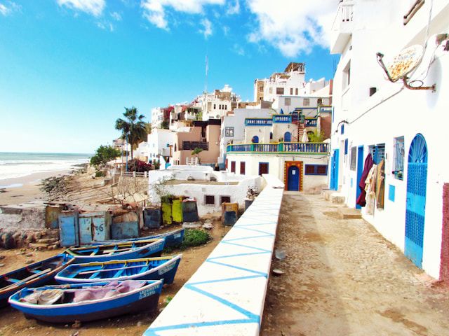 The beach with boats in Taghazout, Morocco. Louis Hansel for Unsplash